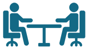 Icon of two people sitting across from each other at a desk